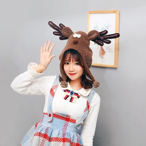 Charming plush reindeer Christmas hat with cute antlers and pom-poms for festive decoration