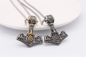 Detail view of Mjolnir Thor hammer necklaces with intricate Celtic knots and Valnut symbol
