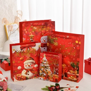 Set of four red Christmas gift bags in different sizes with festive Merry Christmas print