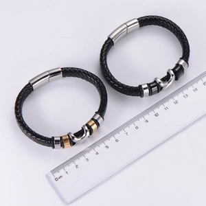 Braided leather bracelets with magnetic steel clasps shown next to a measuring ruler