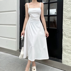 Detail of white spaghetti strap midi dress with cinched waist and A-line silhouette