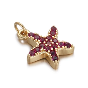 Detail of gold starfish pendant with inlaid magenta gemstones for DIY jewelry