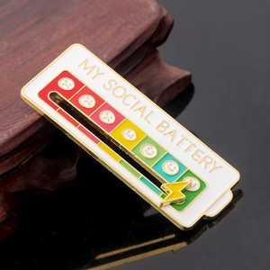 Macro detail of My Social Battery enamel pin with sliding yellow lightning bolt feature