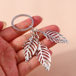 Silver alloy hollow leaf keychain accessory featuring three creative leaf pendants
