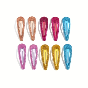 Close-up of ten colorful glitter teardrop snap hair clips in a neat matrix arrangement