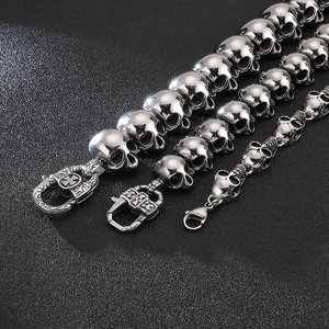 Macro shot of silver stainless steel skull link bracelets with polished metal finishes
