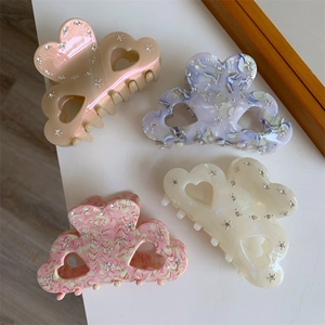 Set of 4 heart-shaped acetate hair claws with marble texture and sparkling rhinestones