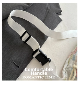 Detail of adjustable white nylon shoulder strap with black plastic buckle and ribbed texture