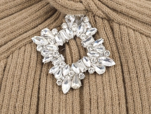 Detail of silver geometric square rhinestone brooch pinned on a brown knit cardigan