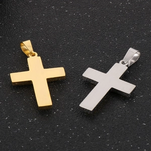 Titanium steel cross pendants in gold and silver finish on a dark starry background