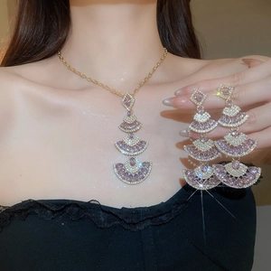 Detail of luxury purple fan-shaped drop tassel necklace and matching long earrings