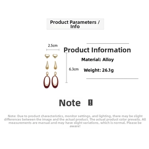 Detail view of 26.1g gold-plated alloy earrings with red enamel hearts and droplets