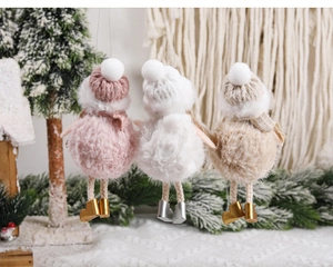 Detailed view of three plush Christmas bird ornaments with knit hats and boots