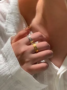 Close-up detail of 18k gold plated hammered texture open rings with vintage metallic finish