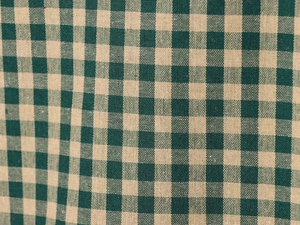 Close-up of green and beige plaid fabric texture on long sleeve shirt detailing