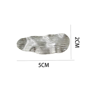 Macro shot of silver metal hair clip with 5CM length and brushed irregular wave texture
