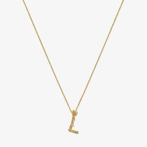 Detail of vintage textured gold letter L pendant with sparkling zircon inlays