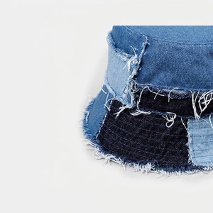 Patchwork denim bucket hat in light and dark blue tones with frayed edge street style