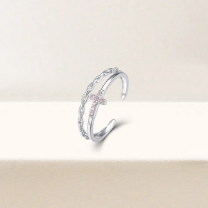 Detail of adjustable S925 silver double layer ring with a pink zircon cross charm