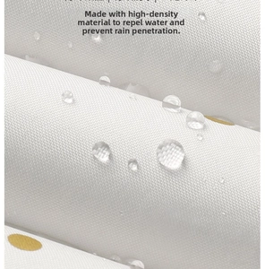 Macro detail of high-density waterproof fabric with gold dots and water-repellent beads