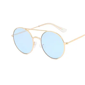Vintage round sunglasses with gold metal frame and light blue ocean lenses for women