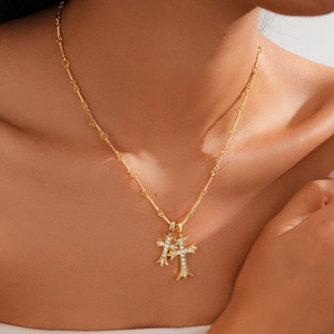 18k gold plated double cross pendant necklace with diamonds on a female model