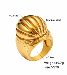 Macro detail of vintage PVD 18k gold plated titanium steel dome ring with textured grooves