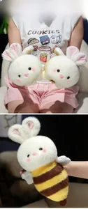 Close-up of cute plush bunny bee doll showing soft fabric texture and striped detail