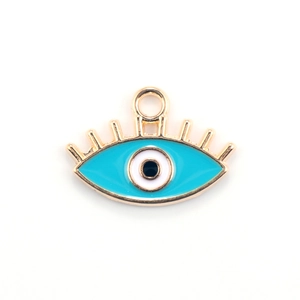Macro shot of blue evil eye charm with golden alloy frame and enamel finish for DIY jewelry