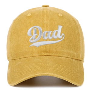 Macro detail of Dad embroidery on washed yellow cotton baseball cap with white stitching
