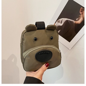 Detail of army green nylon cartoon bear handbag with 3D ears and durable zipper handle