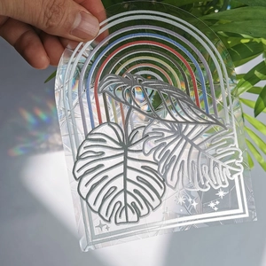 Detailed view of rainbow prism suncatcher film projecting colorful leaf patterns on walls