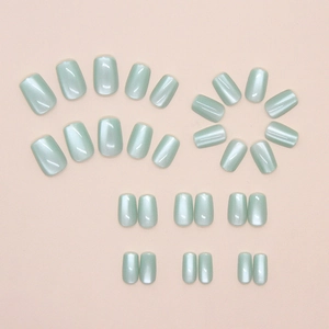 Detailed view of mint green cat-eye press-on nails in various sizes for women