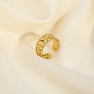 Detail showing vintage hollow leaf patterns on the 18K gold-plated titanium ring