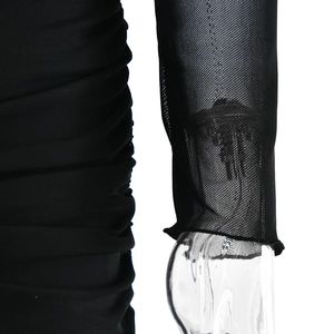 Detail view of mesh sleeves and ruched solid fabric on a black bodycon dress