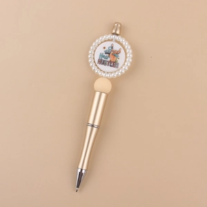 Detailed close-up of champagne gold beaded pen with Hair Hustler stylist design