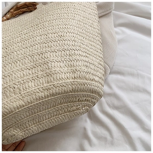 Close-up of beige woven paper rope texture with natural bamboo handle for tote bag