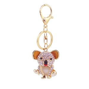 Sparkling gold koala keychain with rhinestones and enamel finish on white background
