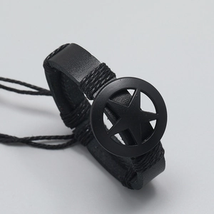 Mens black leather bracelet with star metal plate and woven edge detail on grey background