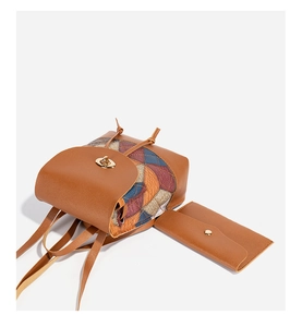 Detail of cube quilted brown leather backpack with colorful geometric fabric and metal twist lock