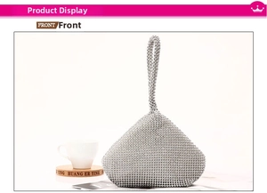 Front view of a silver rhinestone evening clutch bag with triangular 3D structure and handle