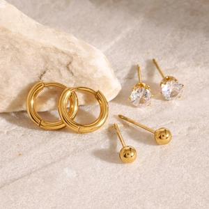 Three-pair stainless steel earring set with gold hoops, zircon studs, and bead earrings