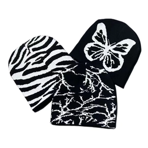 Three-piece set of black and white knitted beanies with butterfly and zebra patterns