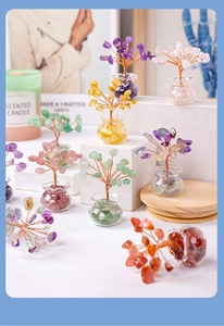 Miniature colorful crystal tree in a glass jar set on a wooden and plaster base