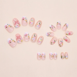 Detail of 3D floral press-on nails with pearls, pink roses and golden bow accents