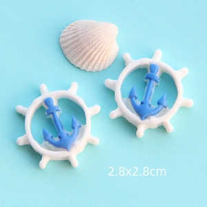 Dettaglio di ciondoli ad ancora e timone in resina 2,8x2,8 cm per creazioni fai-da-te marine