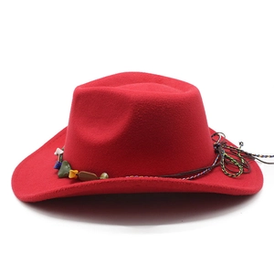 Detail of red wool felt cowboy hat with colorful stones and braided cord trim