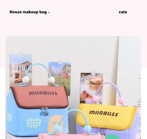 Detail of house-shaped cosmetic bags with color-block design and pearl bead handles