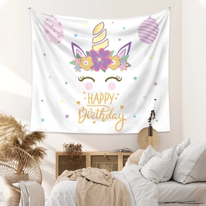 Detail of white Bohemian tapestry with Happy Birthday unicorn motif for wall decoration