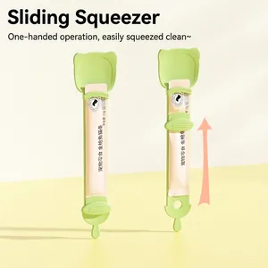 Green cat lickable treat squeezer spoon with easy slide dispenser for feeding